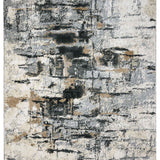 A modern abstract rug with a distressed texture, featuring shades of gray, beige, and black. The pattern resembles an urban landscape, conveying a contemporary feel.