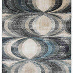 Abstract rug with geometric pattern of interlocking ovals in beige, brown, blue, and purple tones. The design creates a layered, vintage appearance.