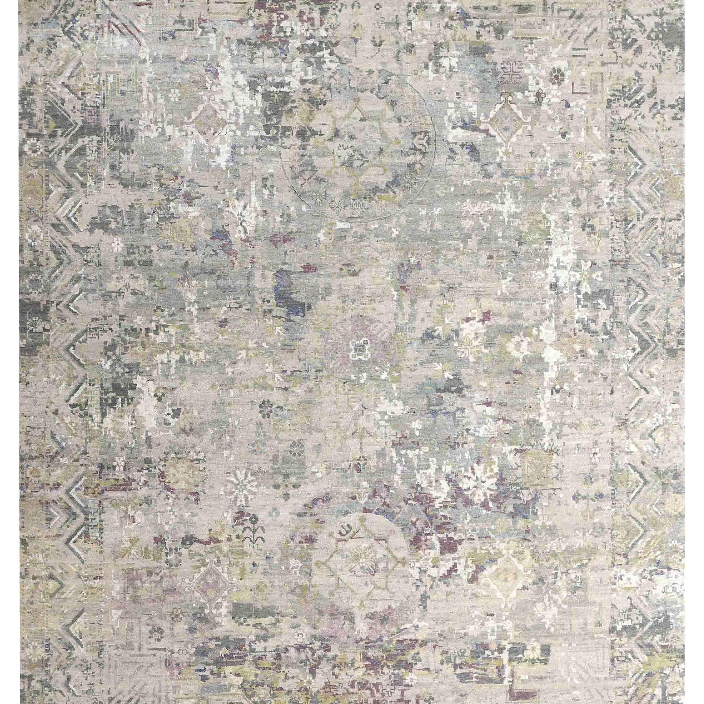 Faded vintage-style rug with intricate geometric and floral patterns in muted tones of beige, blue, and olive, creating an elegant, antique feel.