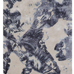 Luxury abstract rug with navy blue floral patterns on beige background, handcrafted for elegance.
