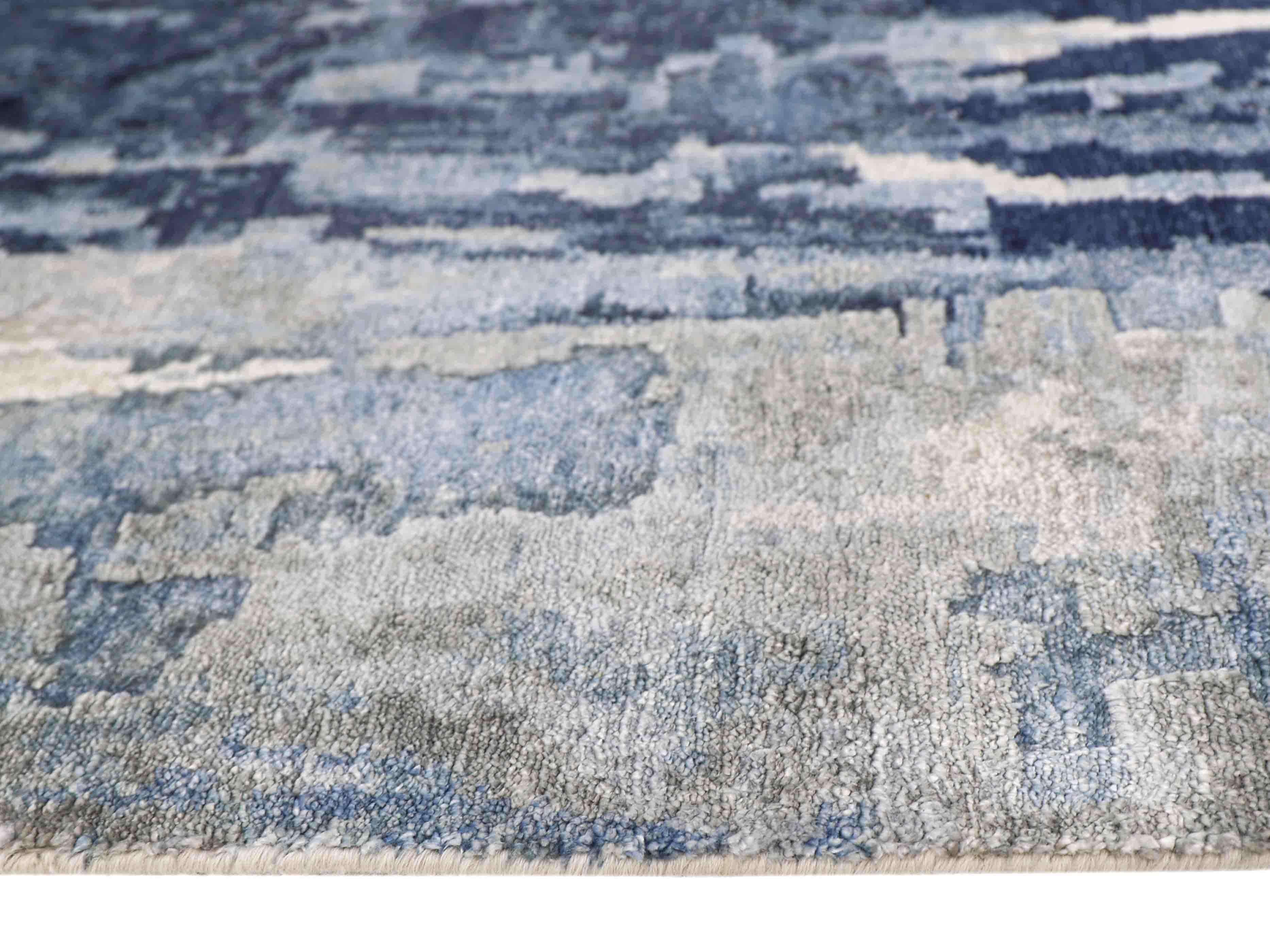 Blue and gray abstract patterned luxury rug with soft texture and modern design