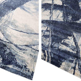 Abstract blue and cream luxury rug with textured brushstroke pattern, ideal for modern home decor