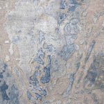 Luxury handcrafted rug with abstract blue and beige patterns, adding elegance to home decor
