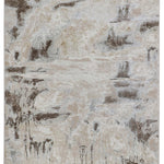 Abstract area rug with a distressed pattern featuring beige, gray, and brown tones. The design resembles a weathered, textured landscape.