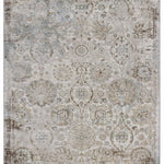 A vintage-style rug with a faded floral and geometric pattern in muted beige, pink, and taupe tones, creating an antique and elegant appearance.