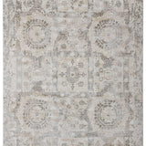 Vintage-style rug with faded intricate patterns of octagons, floral motifs, and abstract shapes in muted beige and gray tones, conveying an antique feel.
