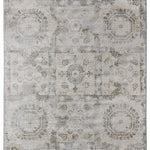 Faded beige rug with intricate, symmetrical patterns of octagons and circular motifs, conveying a vintage and elegant aesthetic.