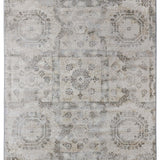 Faded beige rug with intricate, symmetrical patterns of octagons and circular motifs, conveying a vintage and elegant aesthetic.
