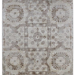 Elegant vintage-style rug with intricate geometric and floral patterns in muted beige and brown tones, conveying a rustic and timeless ambiance.