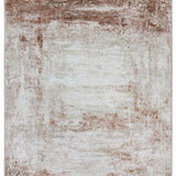 Abstract textured rug in earthy tones, primarily rust and beige, with a distressed pattern radiating from the center, conveying a rustic, cozy feel.