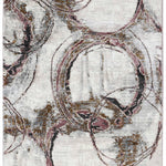 Abstract rug design with swirling circles in gold, pink, and black on a textured off-white background. The patterns create a dynamic, modern feel.