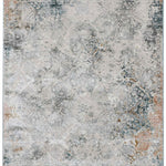 A distressed, ornate area rug featuring an abstract pattern in muted hues of gray, blue, and beige, with hints of rust along the edges and a vintage look.