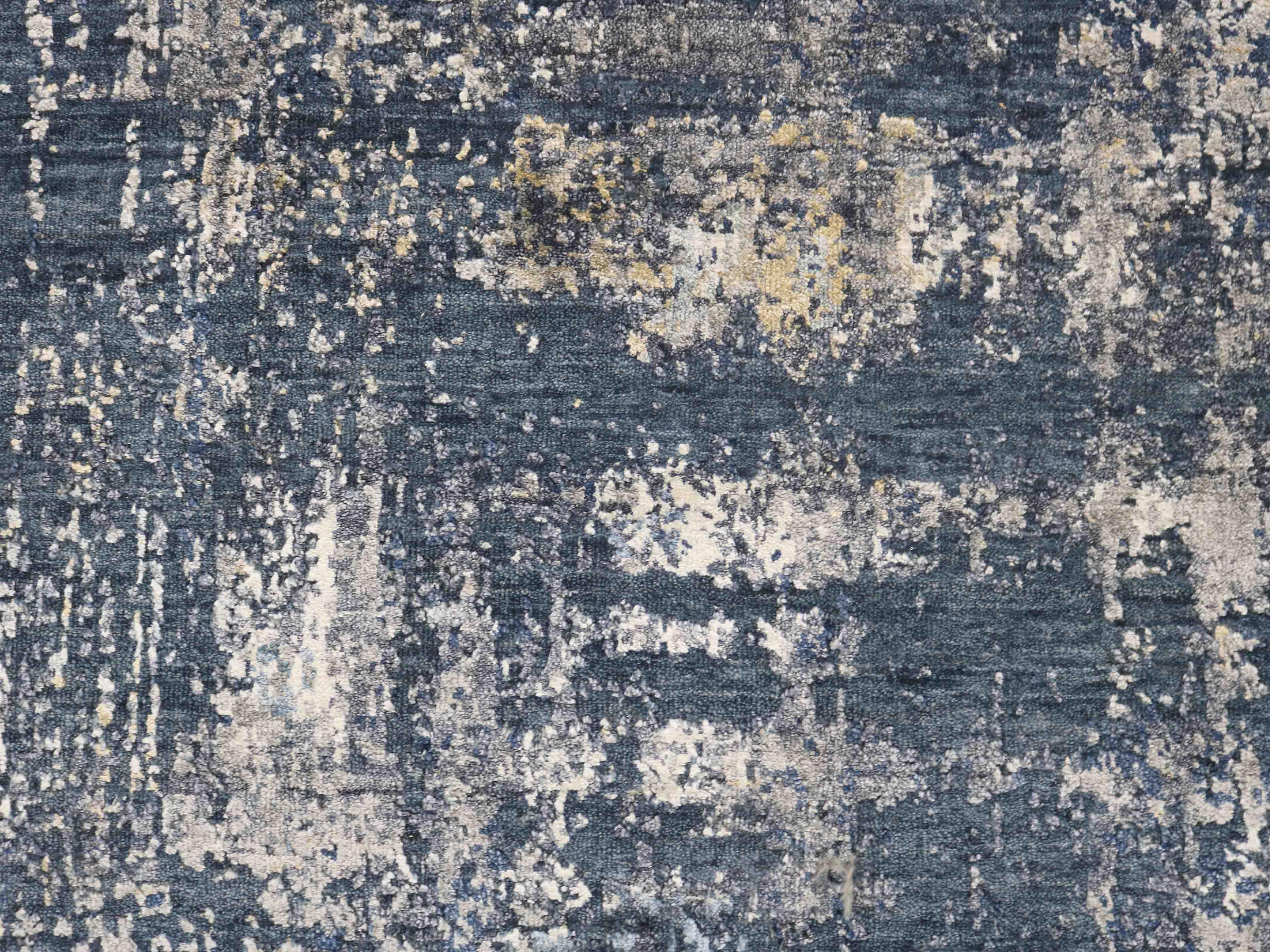 Luxury abstract rug with blue, white, and gold tones for elegant home decor