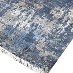 Blue and gray abstract luxury rug with fringe detail, handcrafted for elegant home decor