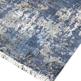 Blue and gray abstract luxury rug with fringe detail, handcrafted for elegant home decor