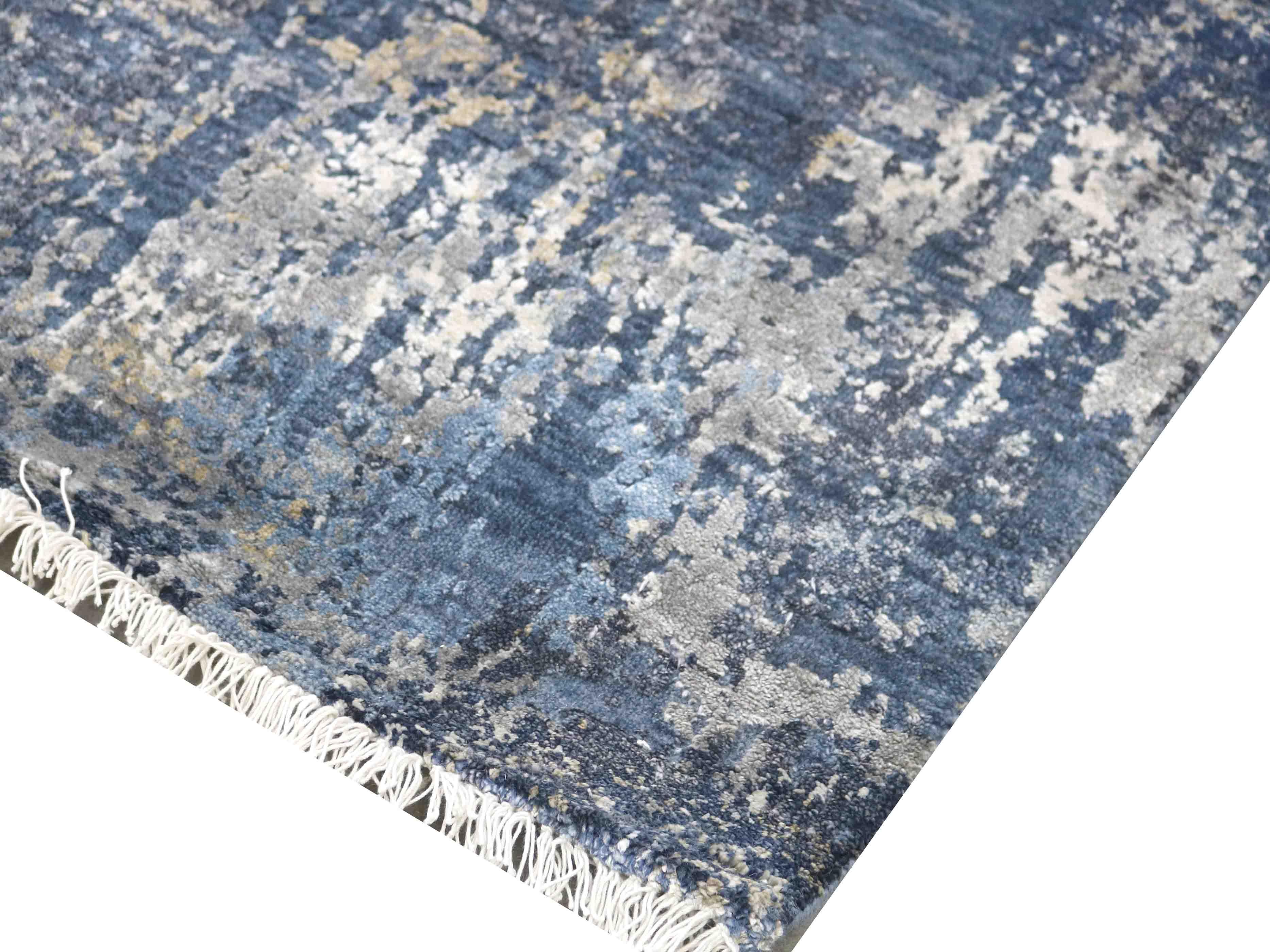 Blue and gray abstract luxury rug with fringe detail, handcrafted for elegant home decor