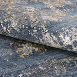 Luxury handcrafted rug with abstract blue, gray, and gold pattern for elegant home decor