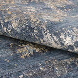 Luxury handcrafted rug with abstract blue, gray, and gold pattern for elegant home decor