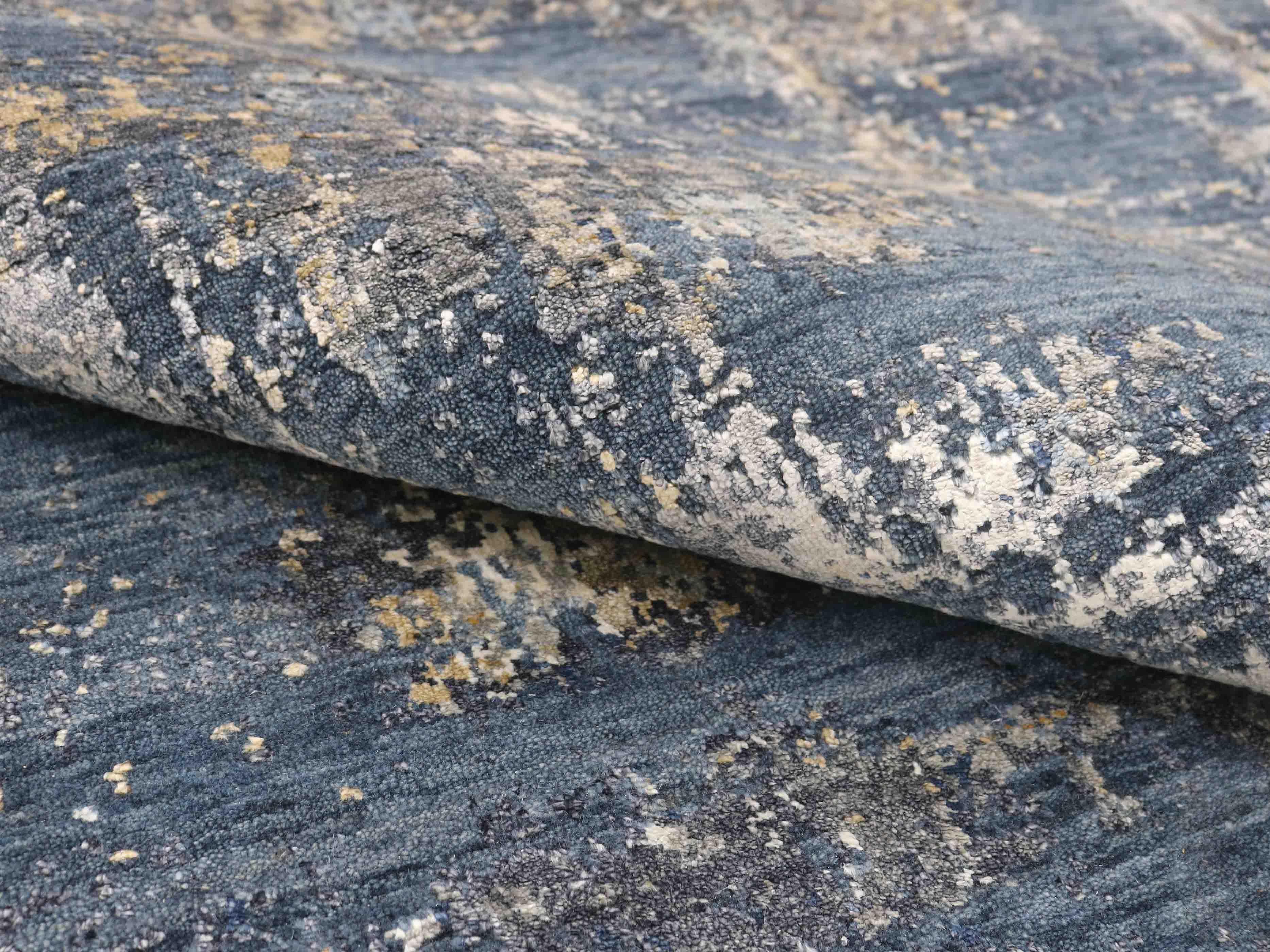 Luxury handcrafted rug with abstract blue, gray, and gold pattern for elegant home decor