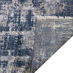 Luxury abstract rug with distressed blue and gold pattern, fringed edge, and elegant texture