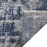 Luxury abstract rug with distressed blue and gold pattern, fringed edge, and elegant texture