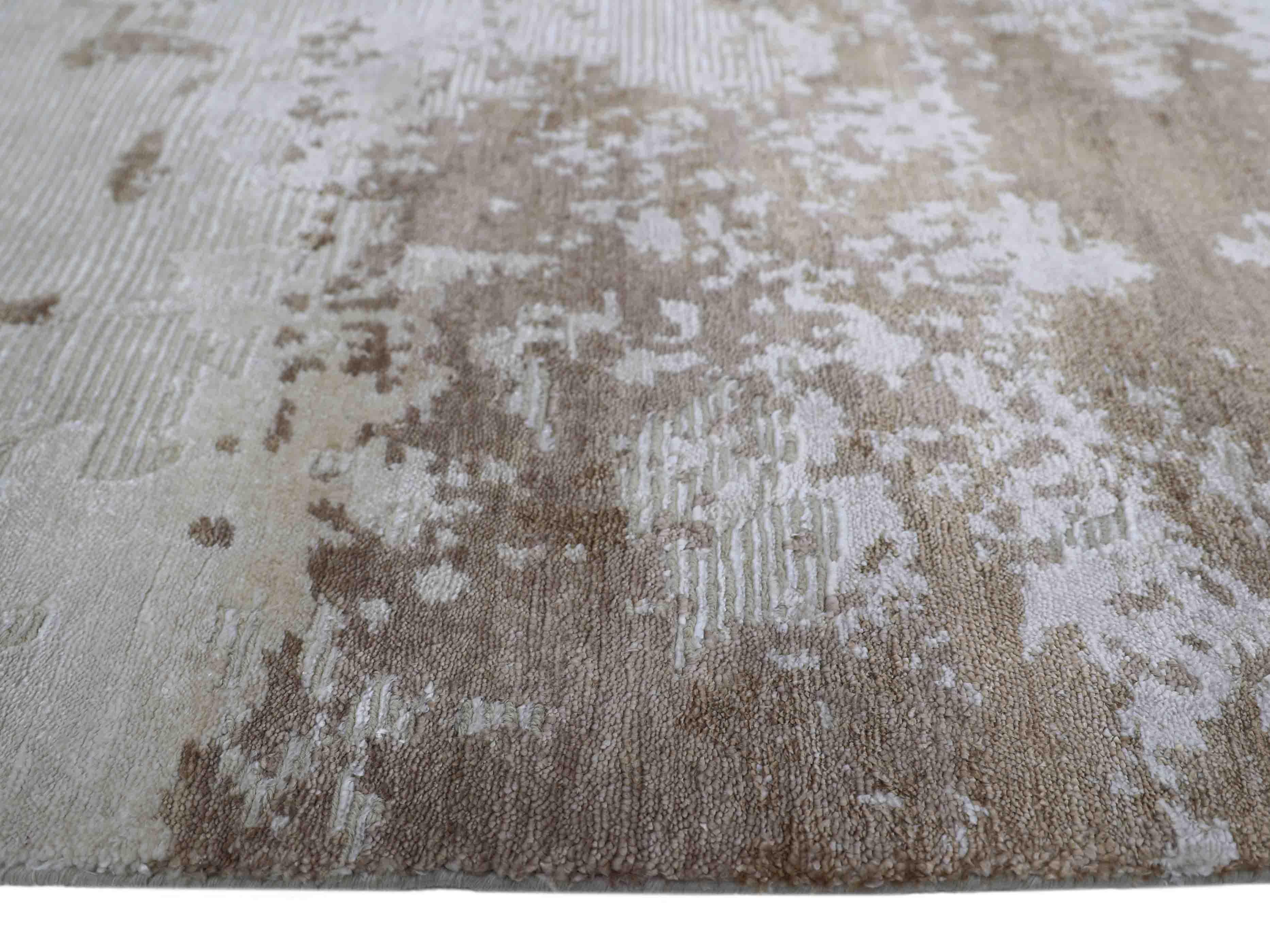 Luxury beige and white patterned rug with textured abstract design, ideal for elegant home decor.