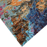 Luxury abstract rug with vibrant blue, orange, and red tones, handcrafted for elegant home decor