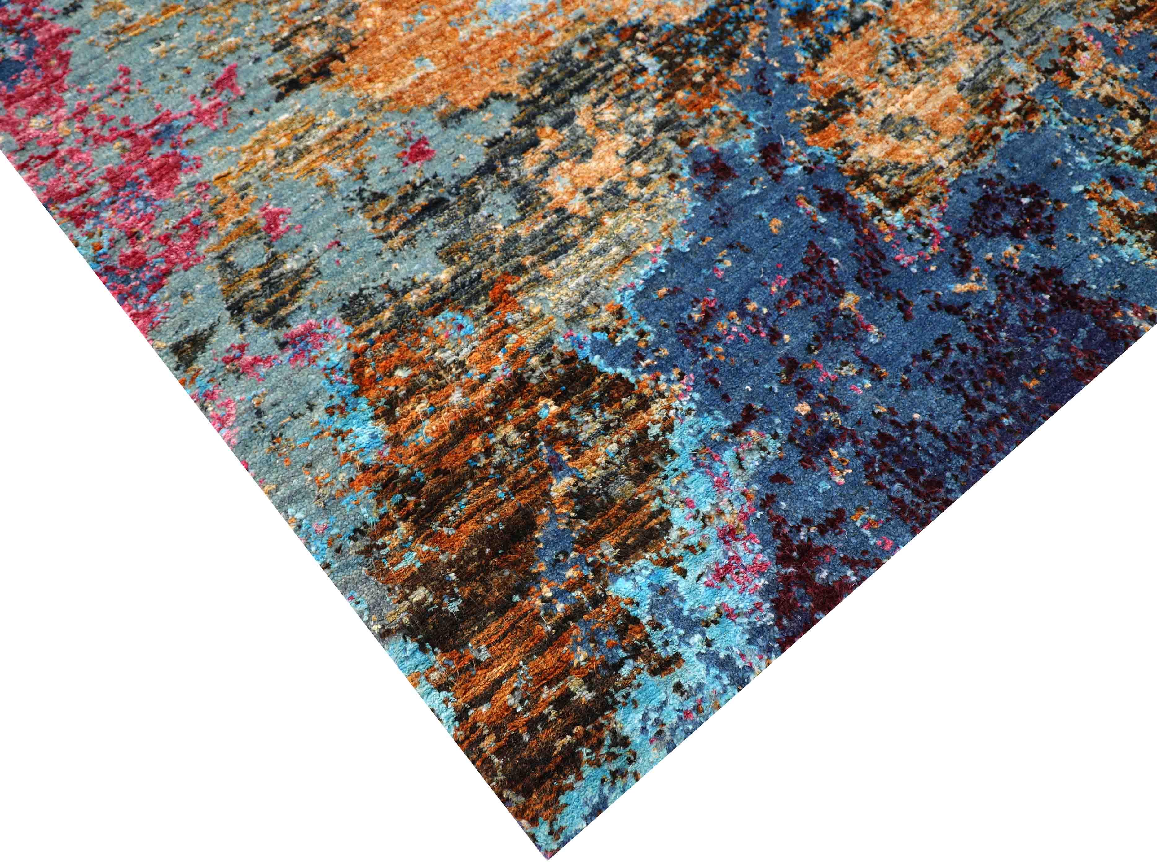 Luxury abstract rug with vibrant blue, orange, and red tones, handcrafted for elegant home decor