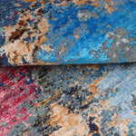 Luxury handcrafted rug with vibrant blue, red, and earthy tones for elegant home decor