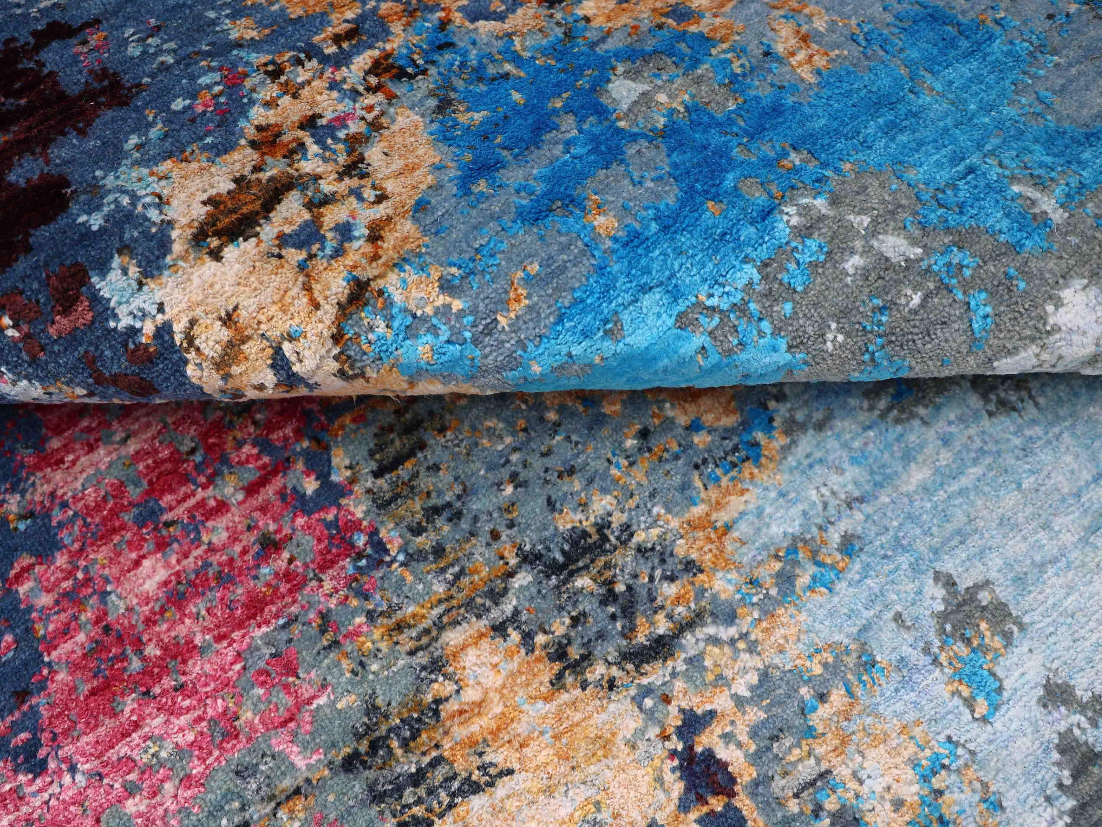 Luxury handcrafted rug with vibrant blue, red, and earthy tones for elegant home decor