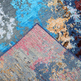 Abstract multicolor luxury rug with blue, red, and pink patterns, showcasing intricate woven texture and vibrant design.