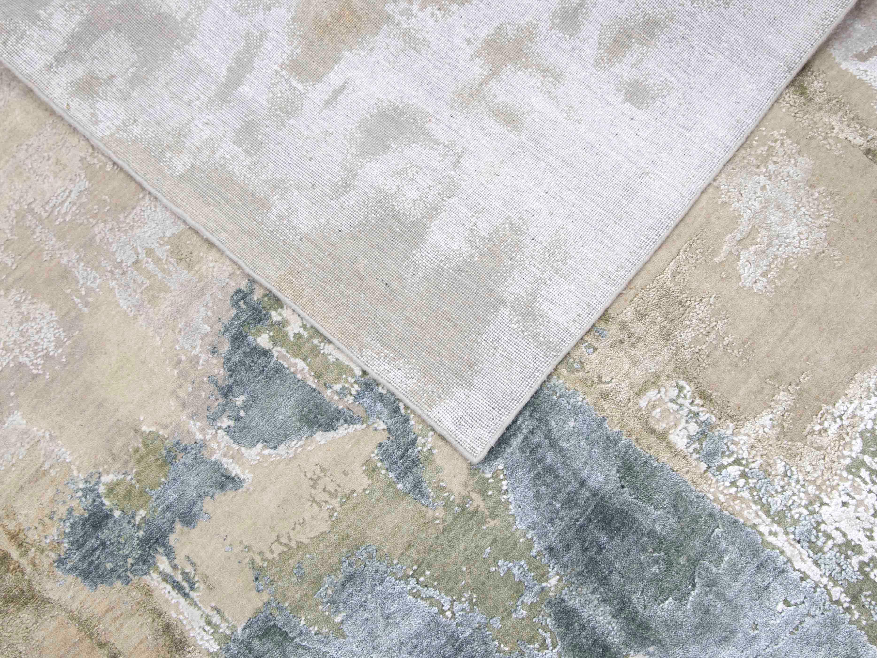Luxury abstract rug with soft gray and beige tones, handcrafted for elegant home decor