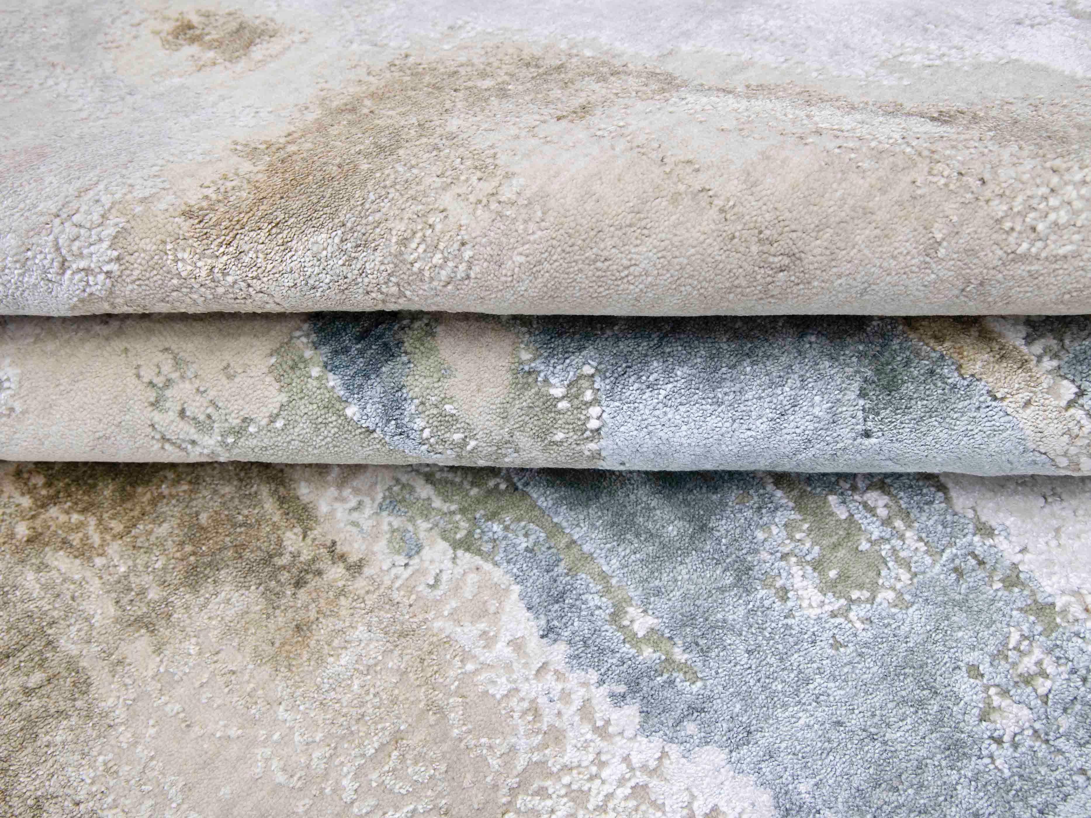 Luxury handcrafted rugs with intricate patterns and soft textures in neutral tones